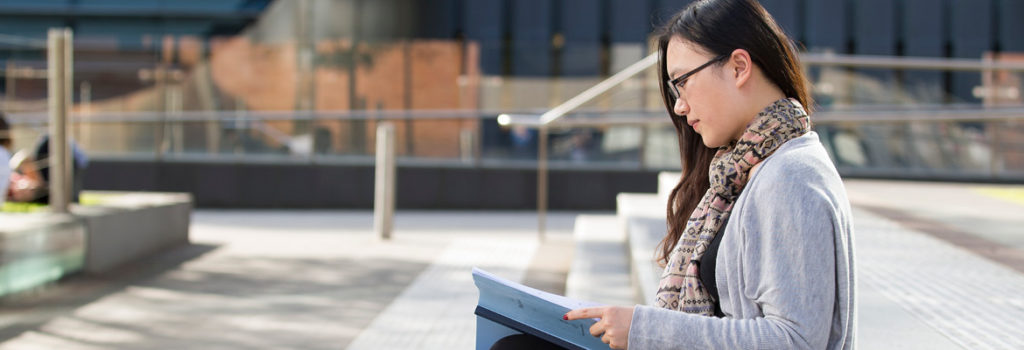 Law student studying on steps